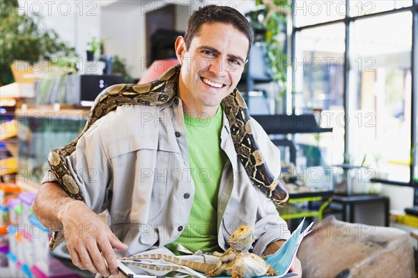 Mixed race pet store owner with animals