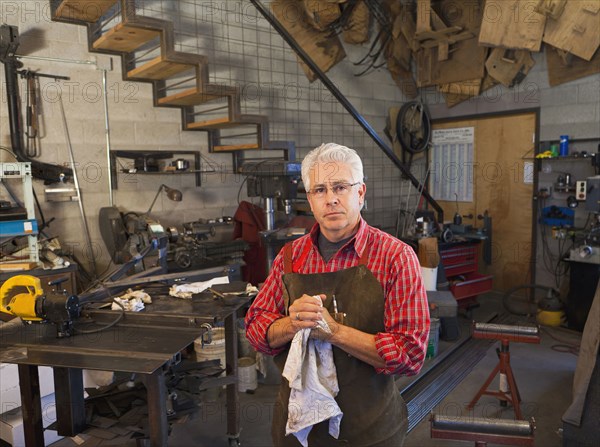 Hispanic craftsman working in shop