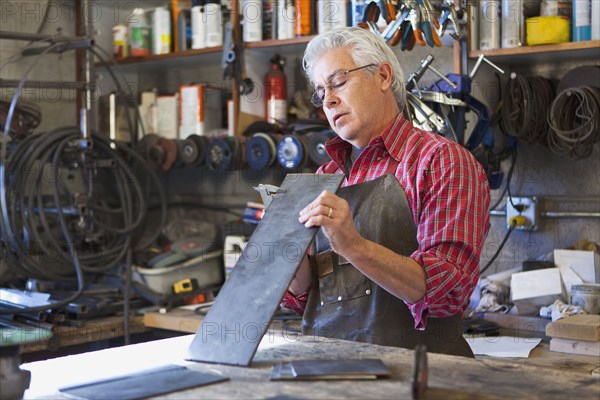 Hispanic craftsman working in shop