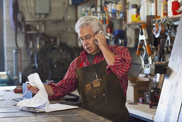 Hispanic craftsman working in shop