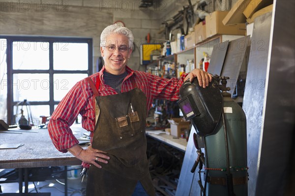 Hispanic craftsman working in shop