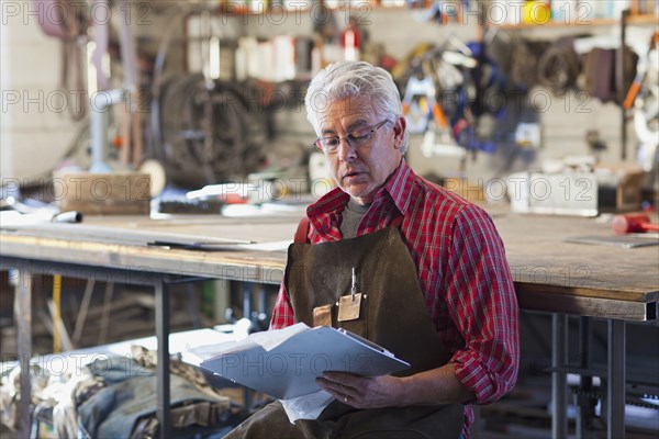 Hispanic craftsman working in shop