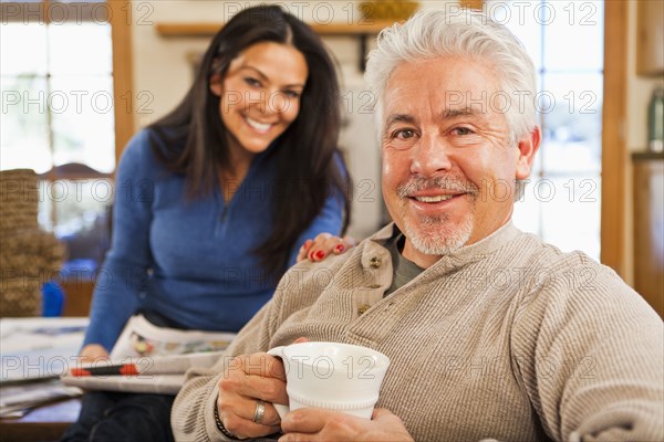 Hispanic couple smiling in living room