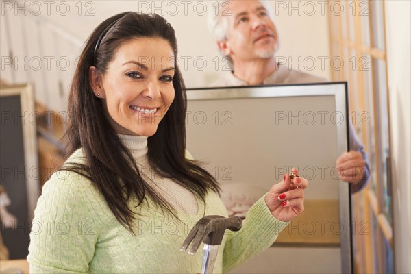 Hispanic couple decorating home together