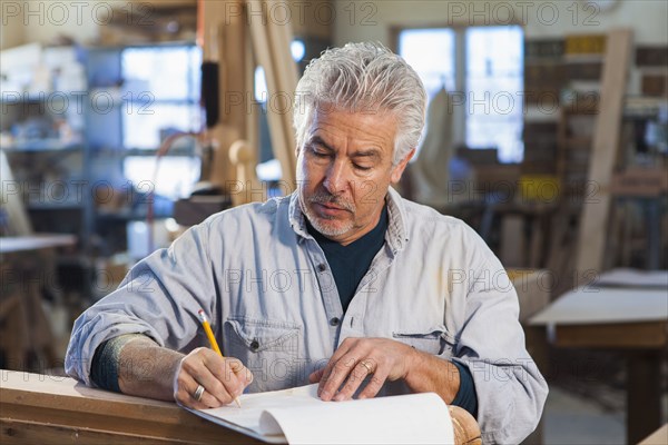 Hispanic craftsman working in studio