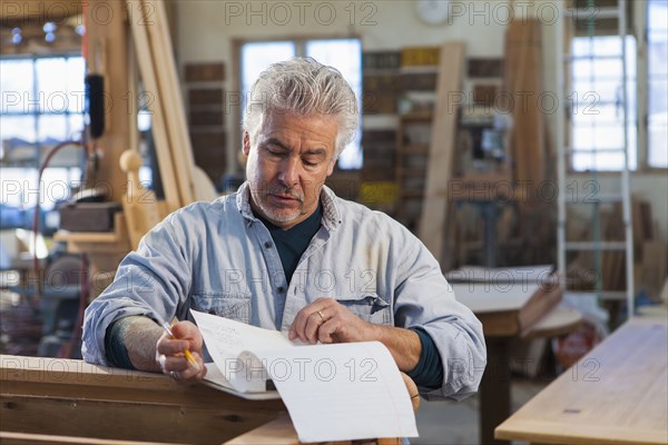 Hispanic craftsman working in studio