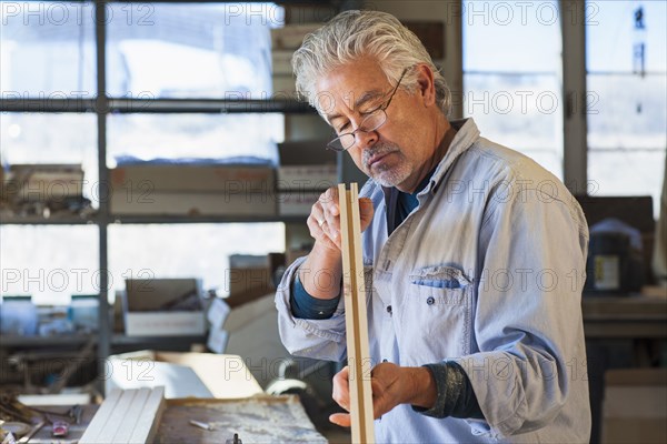 Hispanic craftsman working in studio