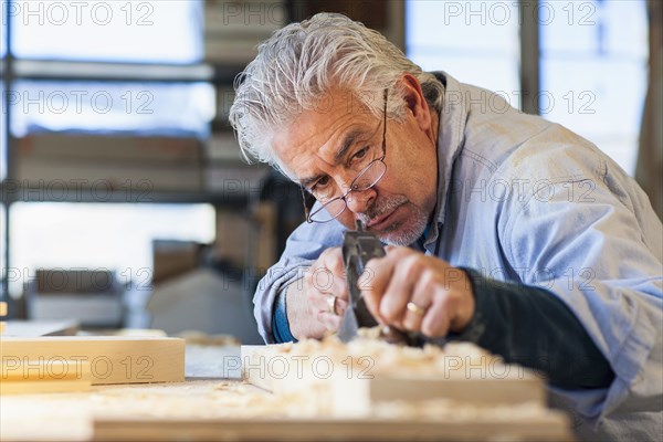 Hispanic craftsman working in studio