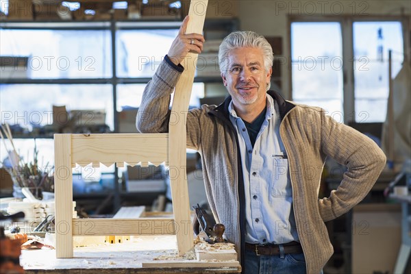 Hispanic craftsman standing in studio