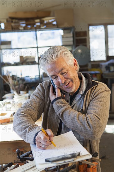 Hispanic craftsman working in studio