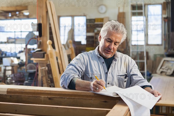 Hispanic craftsman working in studio