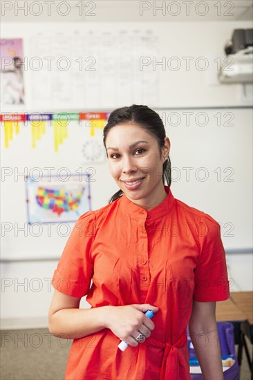 Mixed race teacher smiling in classroom