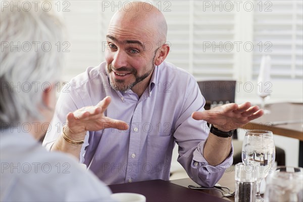 Businessmen talking in cafe