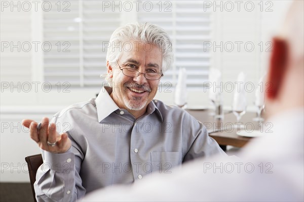 Businessmen talking in cafe