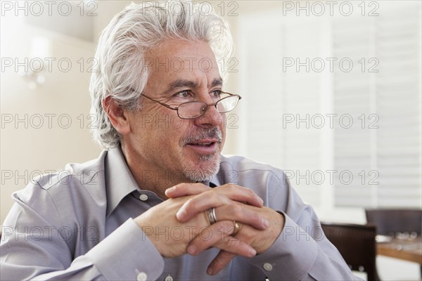 Hispanic businessman sitting in cafe