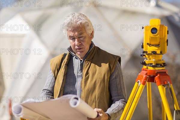 Hispanic surveyor working outdoors