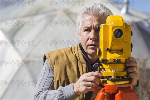 Hispanic surveyor working outdoors