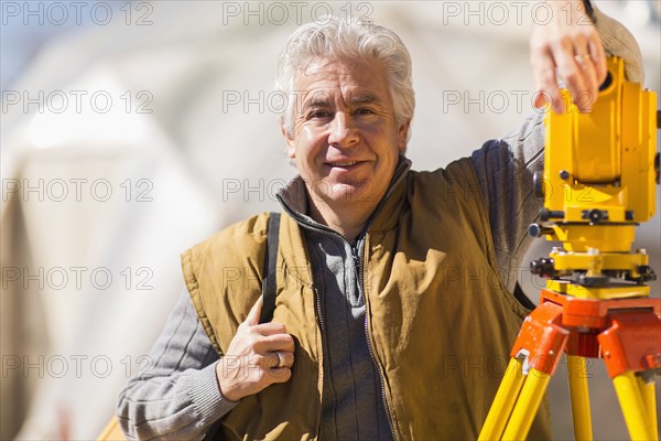 Hispanic surveyor working outdoors