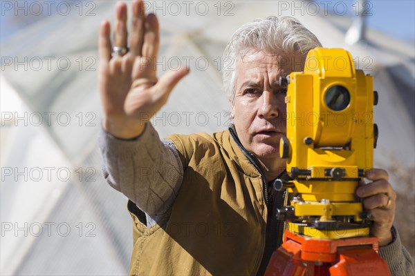 Hispanic surveyor working outdoors