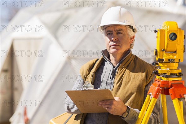 Hispanic surveyor working outdoors