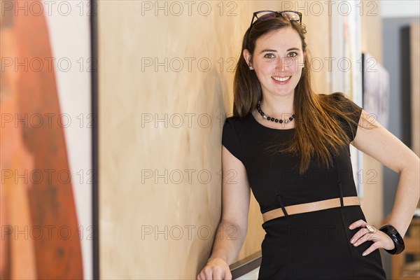 Caucasian woman smiling in art gallery