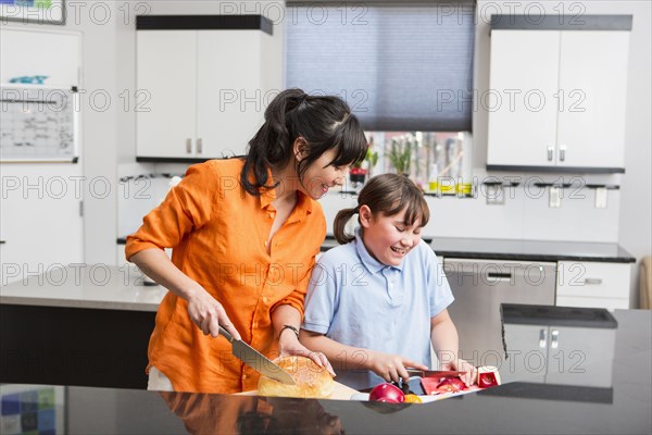 Mother and daughter cooking together