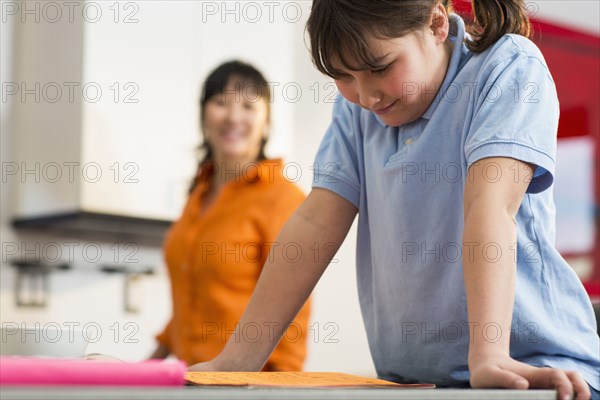 Girl reading homework at desk