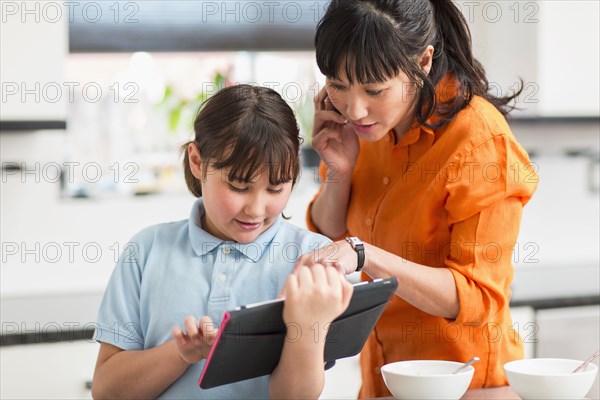 Mother and daughter using tablet computer