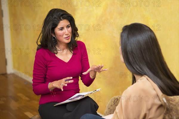 Hispanic women talking indoors