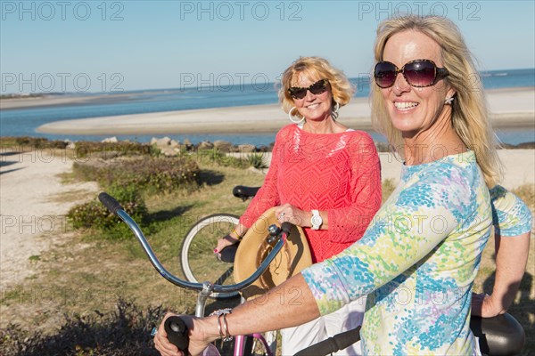 Caucasian women riding bicycles together