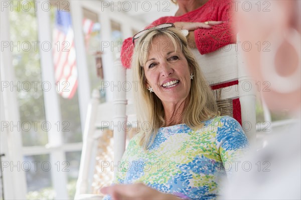 Caucasian woman sitting on porch