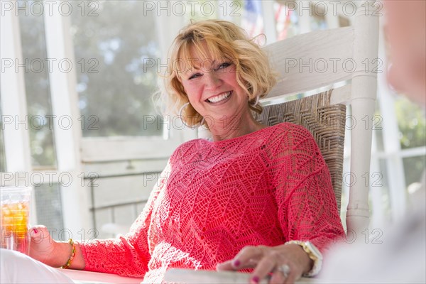 Caucasian woman smiling on porch