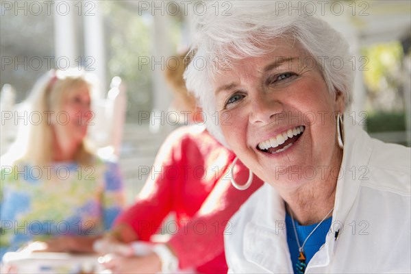 Caucasian woman smiling on porch