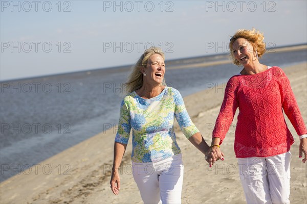 Caucasian women walking on beach