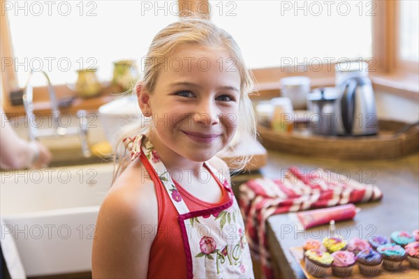 Caucasian girl smiling in kitchen