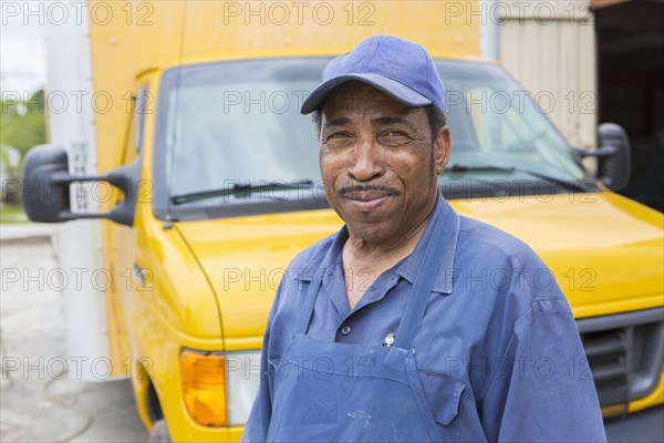 African American worker smiling by truck