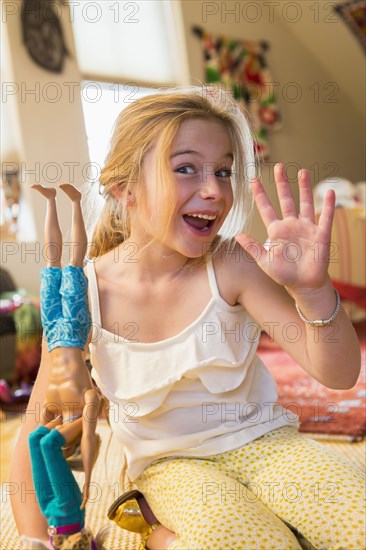 Caucasian girl playing with dolls