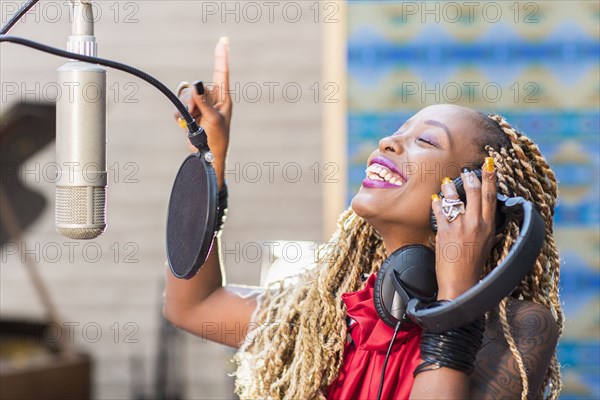 African American singer listening to track in studio