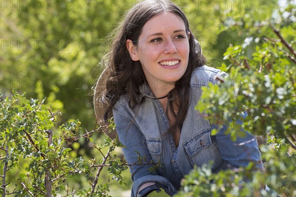 Caucasian woman smiling among bushes