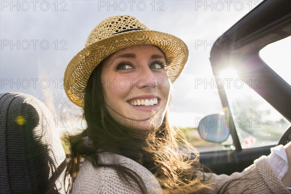 Caucasian woman driving convertible