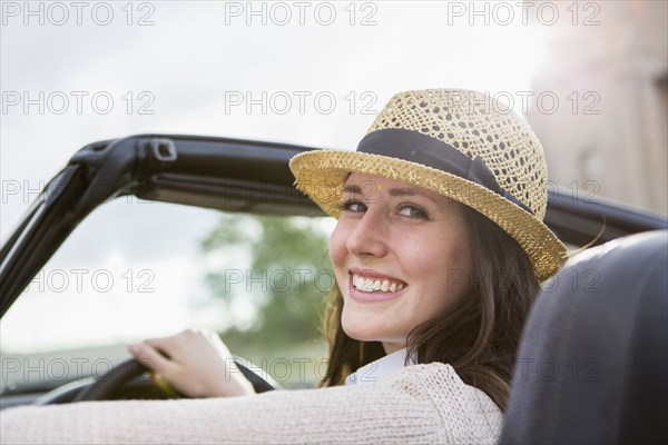 Caucasian woman driving convertible