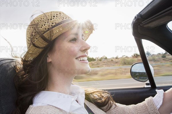 Caucasian woman driving convertible