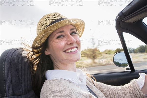 Caucasian woman driving convertible