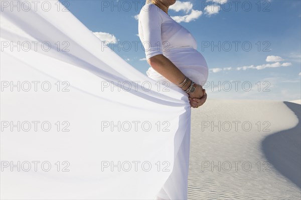 Pregnant Caucasian woman in desert