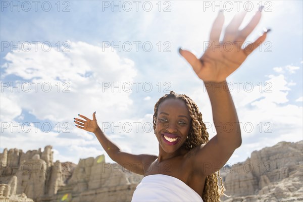 African American woman standing in rock formations