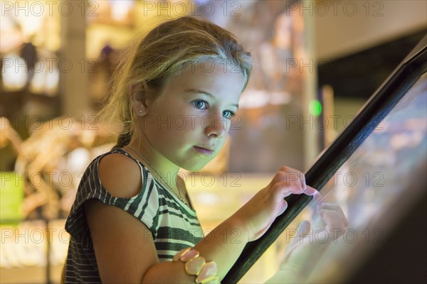 Caucasian girl using touch screen