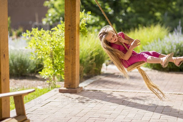 Caucasian girl on swing