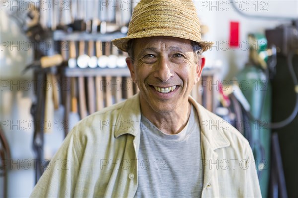 Middle Eastern man smiling in workshop