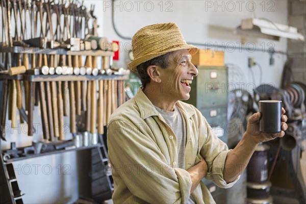 Middle Eastern man smiling in workshop