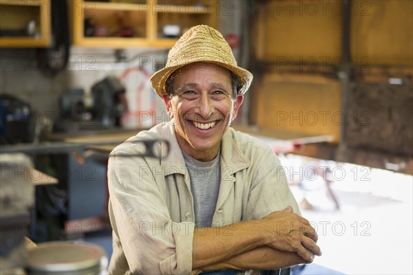 Middle Eastern man smiling in workshop